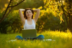 Woman meditating at the park with laptop royalty free stock photos Woman meditating at the park with laptop royalty free stock photos