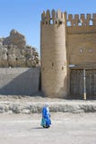 The woman - a Muslim misses the ancient tower Royalty Free Stock Image The woman - a Muslim misses the ancient tower Royalty Free Stock Image