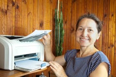 Woman near the printer pulls paper royalty free stock image Woman near the printer pulls paper royalty free stock image