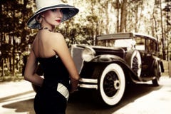 Woman in nice dress and hat against retro car stock image Woman in nice dress and hat against retro car stock image