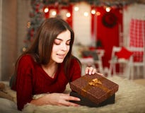 Woman open box with gift on background of Christmas decorations stock images Woman open box with gift on background of Christmas decorations stock images