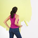 Woman painting wall.