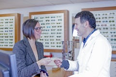 Woman paying at optical shop royalty free stock image Woman paying at optical shop royalty free stock image
