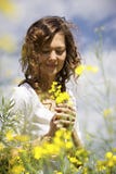 Woman picking flowers in rapeseed field. Stock Photos Woman picking flowers in rapeseed field. Stock Photos