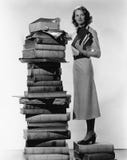 Woman with pile of large books