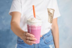 Woman with plastic cup of tasty milk shake on color background royalty free stock photo Woman with plastic cup of tasty milk shake on color background royalty free stock photo