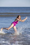 Woman playing and splashing in the ocean royalty free stock photography Woman playing and splashing in the ocean royalty free stock photography