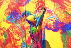 Woman poses for fotos at colorful background.