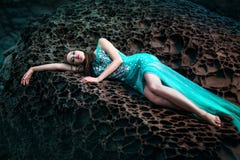 Woman posing on a beach with rocks Royalty Free Stock Image Woman posing on a beach with rocks Royalty Free Stock Image