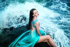 Woman posing on a beach with rocks Stock Photo Woman posing on a beach with rocks Stock Photo