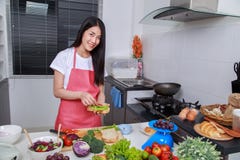 Woman preparing a sandwich in kitchen room stock images Woman preparing a sandwich in kitchen room stock images