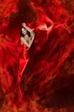 Woman in red waving dress as fire flame