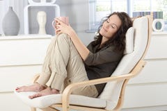 Woman relaxing in armchair Stock Photography Woman relaxing in armchair Stock Photography