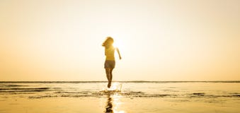 Woman Running In To Sea In The Morning Sunlight Stock Images
