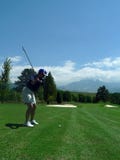 Woman's Golf Swing With Scenic Background