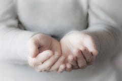 Woman`s hands waiting for alms stock photography Woman`s hands waiting for alms stock photography