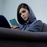 Woman sad bullied on the internet looking message on social network closeup stock photo Woman sad bullied on the internet looking message on social network closeup stock photo