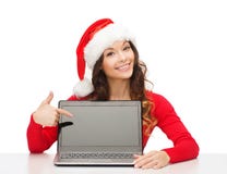 Woman in santa helper hat with laptop computer stock images Woman in santa helper hat with laptop computer stock images