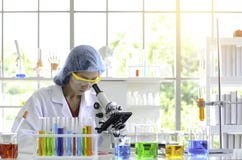 Woman scientist doing experiment with Microscope in laboratory. that have flare light royalty free stock image Woman scientist doing experiment with Microscope in laboratory. that have flare light royalty free stock image