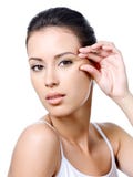 Woman with sensual look pinching skin near the eye stock images Woman with sensual look pinching skin near the eye stock images