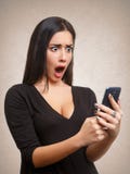 Woman shocked by mobile phone news or message Stock Images Woman shocked by mobile phone news or message Stock Images