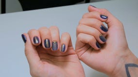 Woman shows her new manicure. Purple nail royalty free stock photo Woman shows her new manicure. Purple nail royalty free stock photo