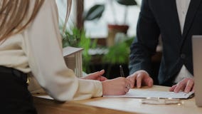 Woman sign mortgage contract, put signature on sale purchase rental agreement, handshaking realtor at meeting with stock video Woman sign mortgage contract, put signature on sale purchase rental agreement, handshaking realtor at meeting with stock video