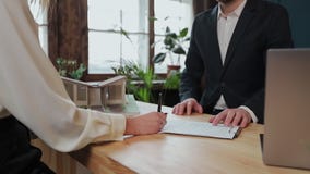 Woman sign mortgage contract, put signature on sale purchase rental agreement, handshaking realtor at meeting with stock footage Woman sign mortgage contract, put signature on sale purchase rental agreement, handshaking realtor at meeting with stock footage