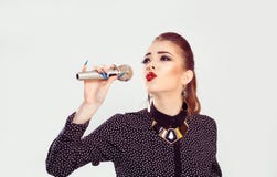 A woman singing at the microphone stock images A woman singing at the microphone stock images
