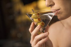Woman sipping martini.