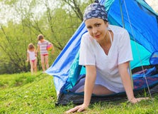 Woman Sits Inside Tent, Kids Game On Lawn Royalty Free Stock Photography