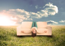 Woman sitting upside down on couch in field Royalty Free Stock Photos Woman sitting upside down on couch in field Royalty Free Stock Photos