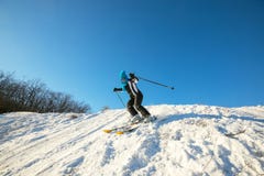 Woman skier skiing downhill in the winter forest Royalty Free Stock Photo Woman skier skiing downhill in the winter forest Royalty Free Stock Photo