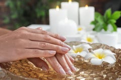 Woman Soaking Her Hands In Bowl Of Water And Flowers. Spa Treatment Royalty Free Stock Image