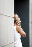 Woman speaking on telephone near office stock images Woman speaking on telephone near office stock images