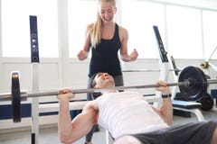 Woman Spotting Man Lifting Barbell in Gym stock images Woman Spotting Man Lifting Barbell in Gym stock images