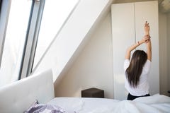 woman stretching in bed after wake up in morning with sunlight royalty free stock photo woman stretching in bed after wake up in morning with sunlight royalty free stock photo