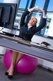 Woman Stretching In Office Stock Images