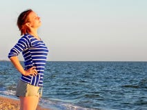 Woman in a striped t-shirt on the sea royalty free stock photo Woman in a striped t-shirt on the sea royalty free stock photo