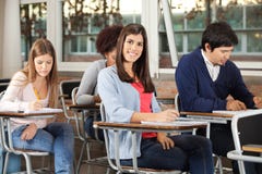 Woman With Students Writing Exam In Classroom royalty free stock photos Woman With Students Writing Exam In Classroom royalty free stock photos