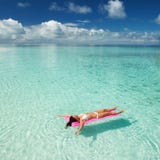 Woman Swim And Relax In The Sea. Happy Island Lifestyle. White Sand, Crystal-blue Sea Of Tropical Beach. Vacation At Paradise. Stock Photos