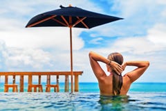 Woman swim in beach infinity pool with sea view Stock Photos Woman swim in beach infinity pool with sea view Stock Photos