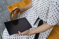 Woman with tablet at outdoor cafe stock photo Woman with tablet at outdoor cafe stock photo