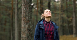 Woman take a deep breath and enjoy the nature in forest. meditation and stress relief