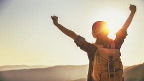 Woman tourist at top of mountain at sunset outdoors during hike stock photography Woman tourist at top of mountain at sunset outdoors during hike stock photography