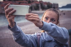 Woman traveler making selfie mobile photo on smart phone during travel holidays at beach for social media networking stock images Woman traveler making selfie mobile photo on smart phone during travel holidays at beach for social media networking stock images