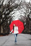 Woman with umbrella in fall in rain stock photo Woman with umbrella in fall in rain stock photo