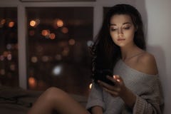 Woman use of mobile phone indoors at night royalty free stock image Woman use of mobile phone indoors at night royalty free stock image