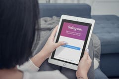 Woman using Instagram app on a brand new Apple iPad Pro Silver royalty free stock image Woman using Instagram app on a brand new Apple iPad Pro Silver royalty free stock image