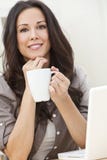 Woman Using Laptop Computer Drinking Tea or Coffee Stock Photography Woman Using Laptop Computer Drinking Tea or Coffee Stock Photography